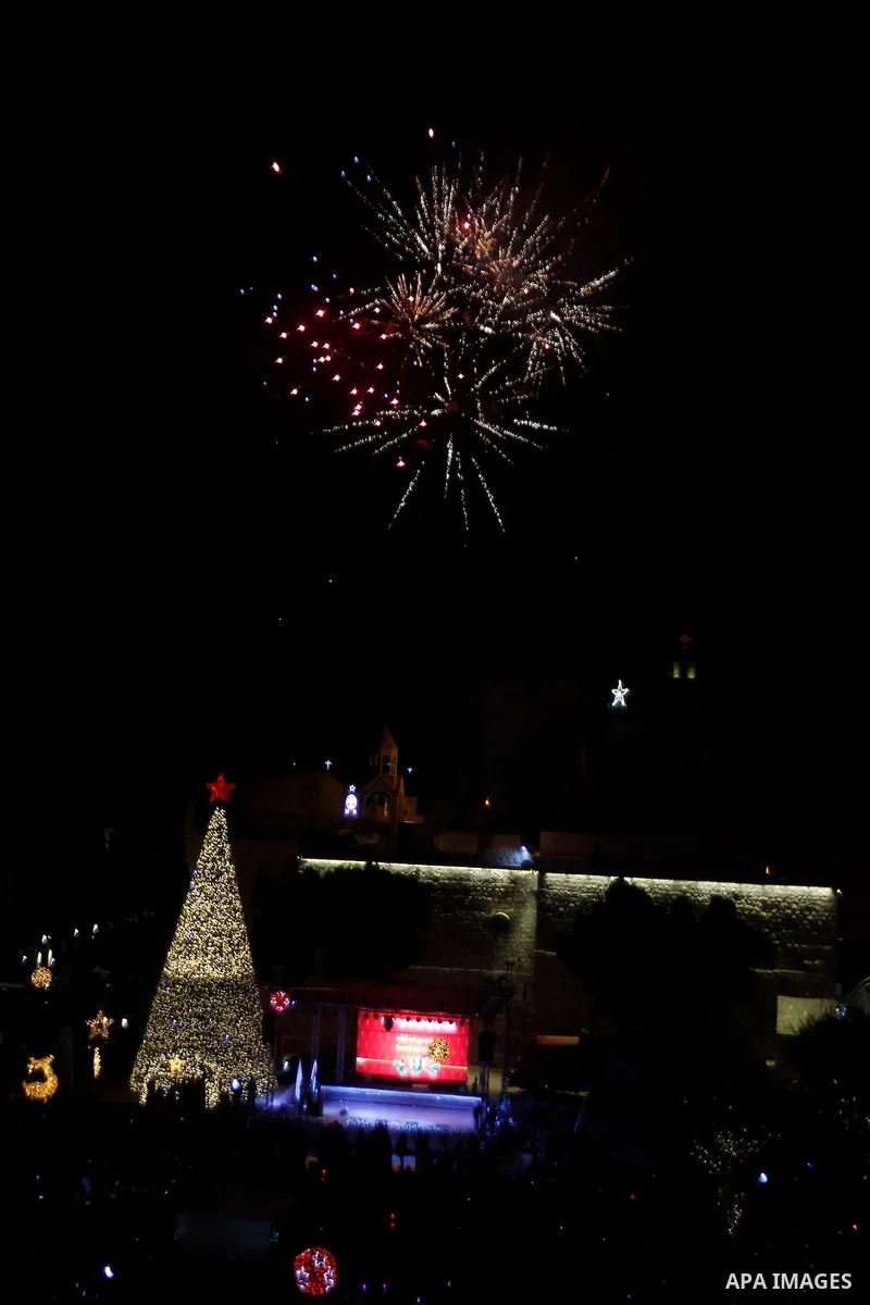 Palestinian Christians watch fireworks marking the lighting of a Christmas tree on December 3, 2016 at the Manger Square near the Church of the Nativity, revered as the site of Jesus Christ's birth, in the biblical West...