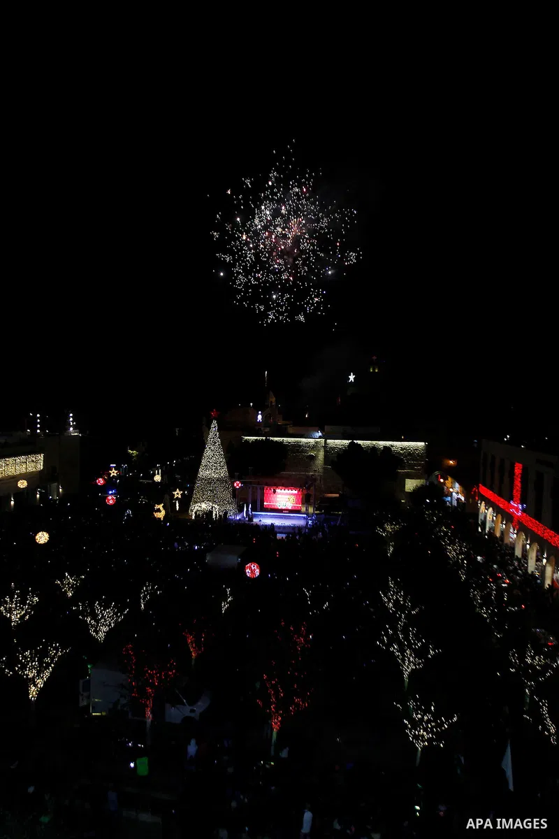Palestinian Christians watch fireworks marking the lighting of a Christmas tree on December 3, 2016 at the Manger Square near the Church of the Nativity, revered as the site of Jesus Christ's birth, in the biblical West...