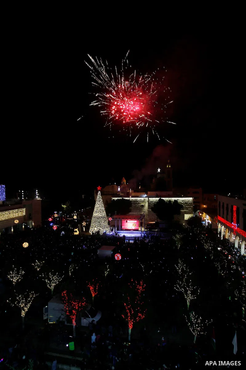 Palestinian Christians watch fireworks marking the lighting of a Christmas tree on December 3, 2016 at the Manger Square near the Church of the Nativity, revered as the site of Jesus Christ's birth, in the biblical West...