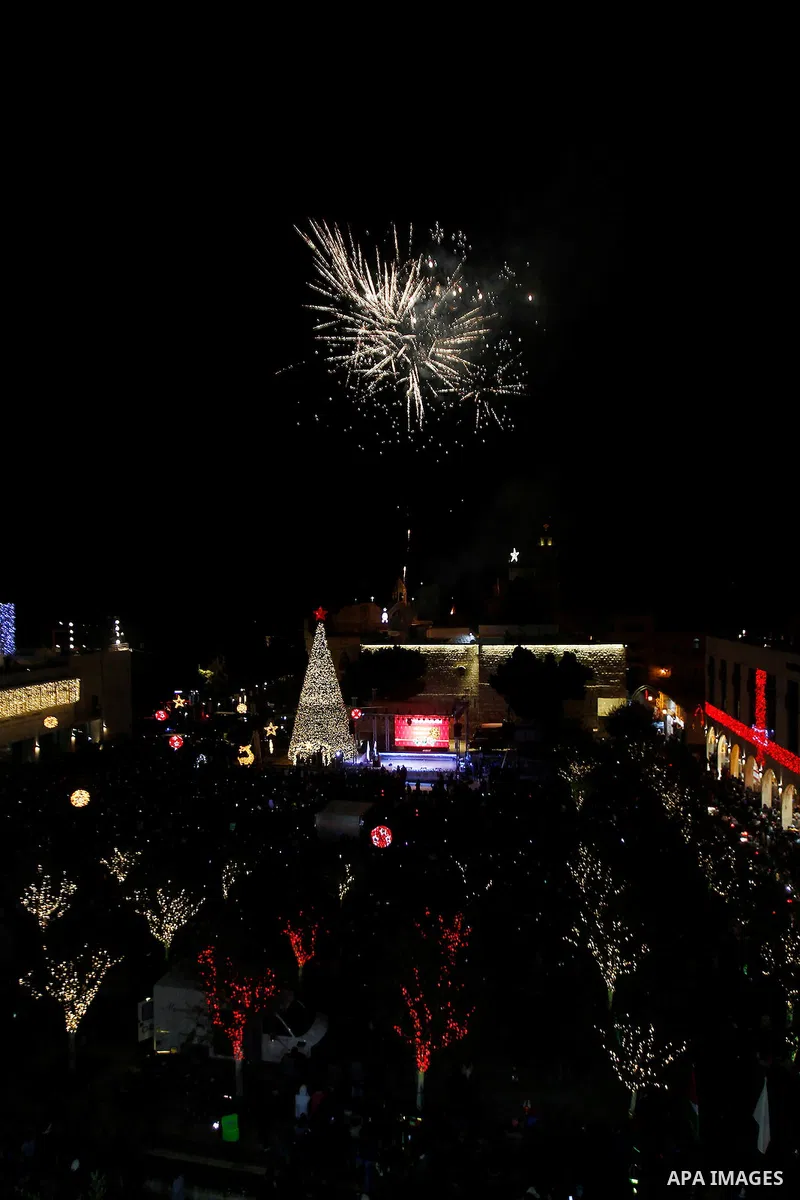 Palestinian Christians watch fireworks marking the lighting of a Christmas tree on December 3, 2016 at the Manger Square near the Church of the Nativity, revered as the site of Jesus Christ's birth, in the biblical West...
