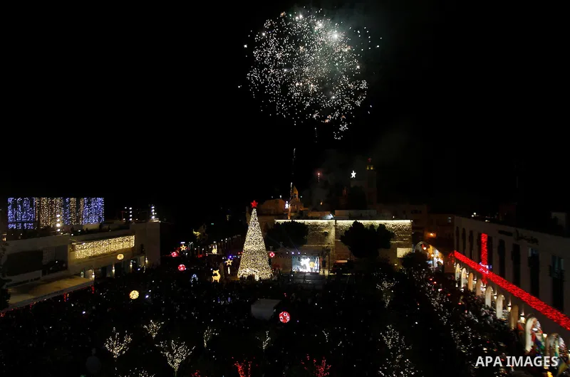 Palestinian Christians watch fireworks marking the lighting of a Christmas tree on December 3, 2016 at the Manger Square near the Church of the Nativity, revered as the site of Jesus Christ's birth, in the biblical West...