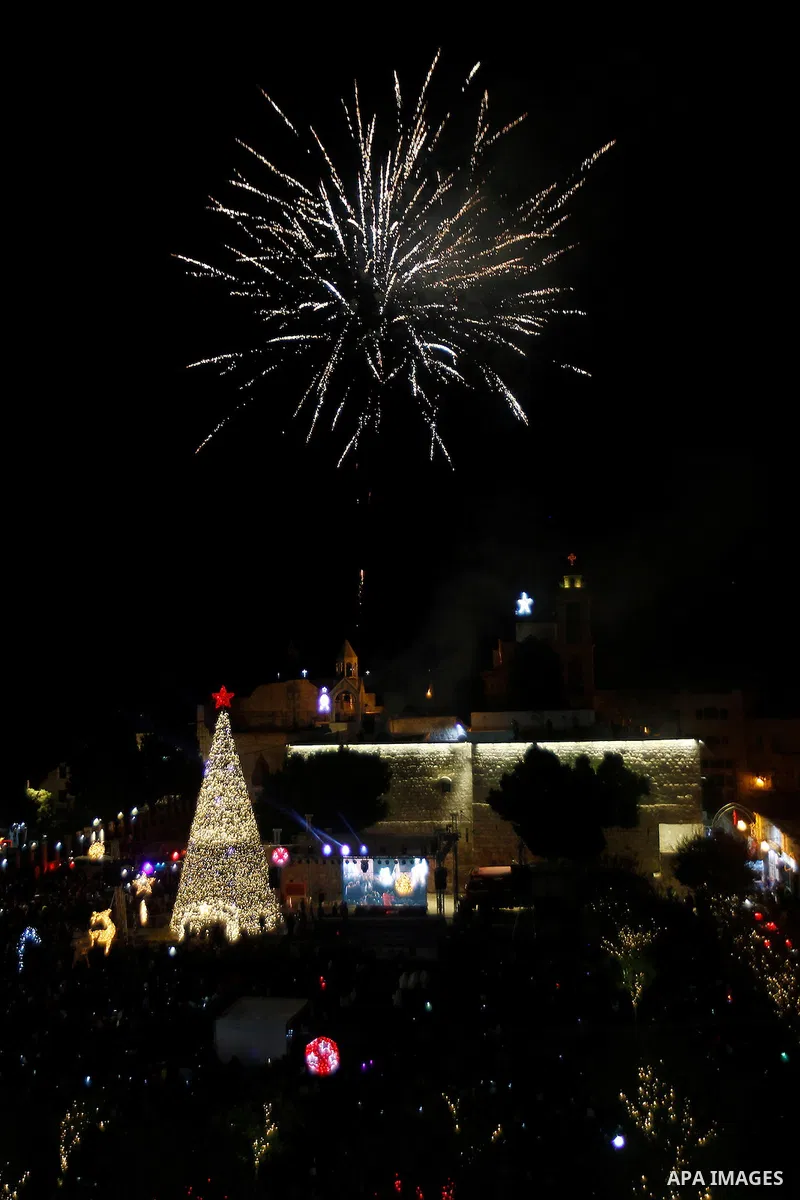 Palestinian Christians watch fireworks marking the lighting of a Christmas tree on December 3, 2016 at the Manger Square near the Church of the Nativity, revered as the site of Jesus Christ's birth, in the biblical West...