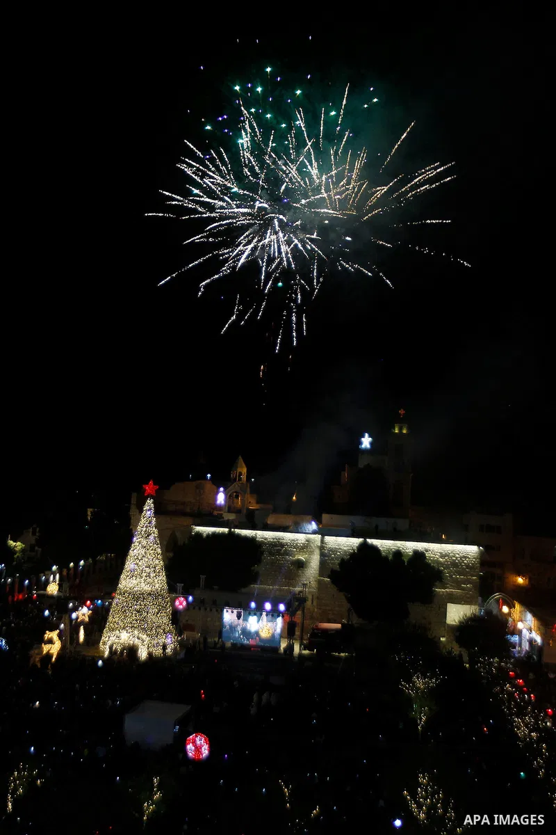 Palestinian Christians watch fireworks marking the lighting of a Christmas tree on December 3, 2016 at the Manger Square near the Church of the Nativity, revered as the site of Jesus Christ's birth, in the biblical West...