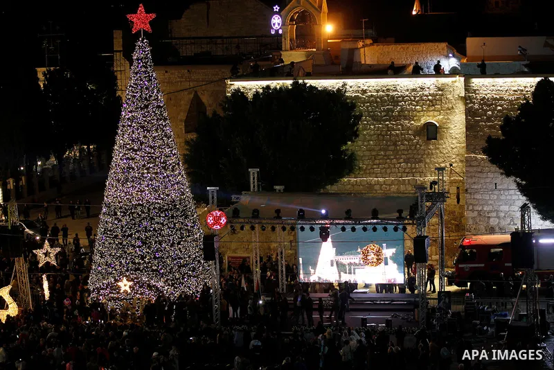 Palestinian Christians watch fireworks marking the lighting of a Christmas tree on December 3, 2016 at the Manger Square near the Church of the Nativity, revered as the site of Jesus Christ's birth, in the biblical West...