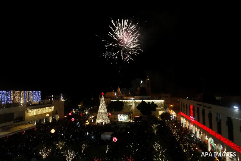 Palestinian Christians watch fireworks marking the lighting of a Christmas tree on December 3, 2016 at the Manger Square near the Church of the Nativity, revered as the site of Jesus Christ's birth, in the biblical West...