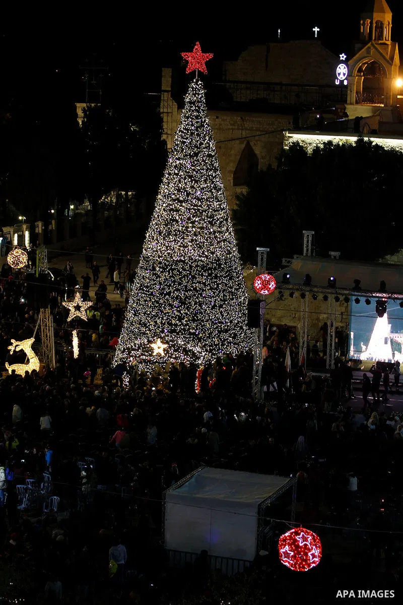 Palestinian Christians watch fireworks marking the lighting of a Christmas tree on December 3, 2016 at the Manger Square near the Church of the Nativity, revered as the site of Jesus Christ's birth, in the biblical West...