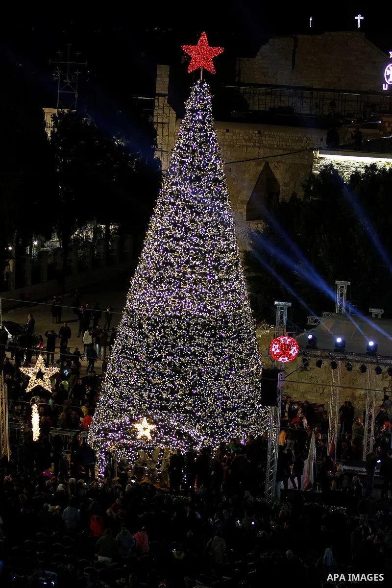 Palestinian Christians watch fireworks marking the lighting of a Christmas tree on December 3, 2016 at the Manger Square near the Church of the Nativity, revered as the site of Jesus Christ's birth, in the biblical West...
