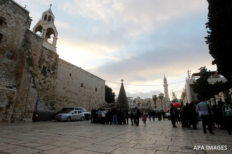 Palestinian Christians attend marking the lighting of a Christmas tree on December 3, 2016 at the Manger Square near the Church of the Nativity, revered as the site of Jesus Christ's birth, in the biblical West Bank town...