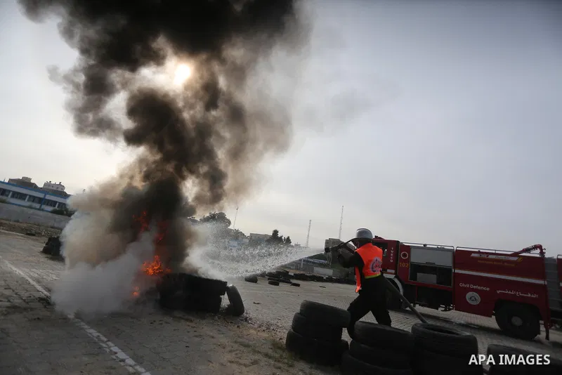 Palestinian Civil Defense members take part in a drill, in Gaza city, on December 4, 2016. Photo by Mohammed Asad