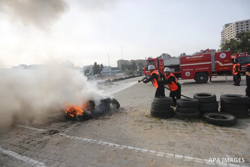 Palestinian Civil Defense members take part in a drill, in Gaza city, on December 4, 2016. Photo by Mohammed Asad