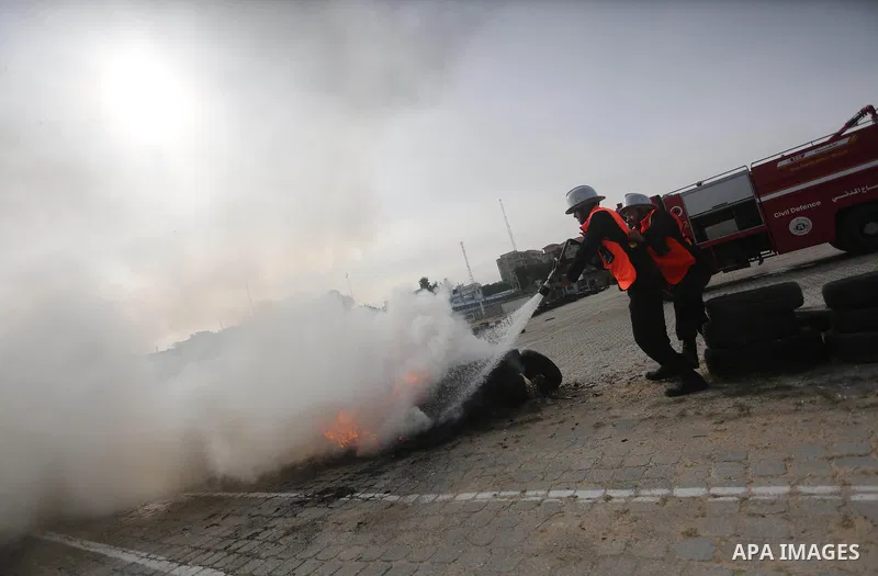 Palestinian Civil Defense members take part in a drill, in Gaza city, on December 4, 2016. Photo by Mohammed Asad