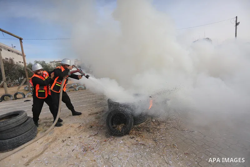 Palestinian Civil Defense members take part in a drill, in Gaza city, on December 4, 2016. Photo by Mohammed Asad
