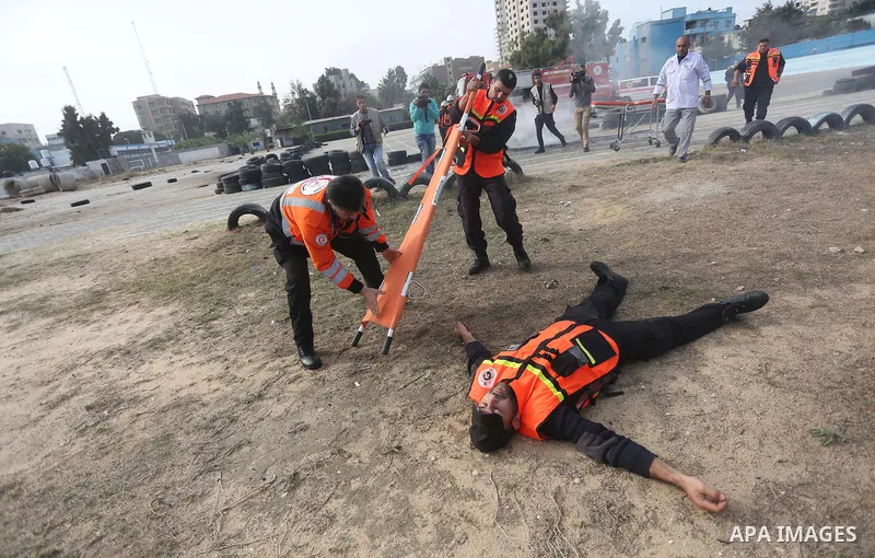 Palestinian Civil Defense members take part in a drill, in Gaza city, on December 4, 2016. Photo by Mohammed Asad