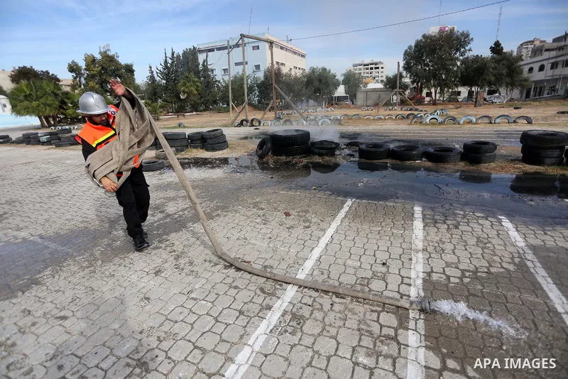Palestinian Civil Defense members take part in a drill, in Gaza city, on December 4, 2016. Photo by Mohammed Asad