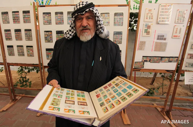 Palestinians attend the first exhibition of coins and postage stamps, in Gaza City, on December 4, 2016. Photo by Ashraf Amra