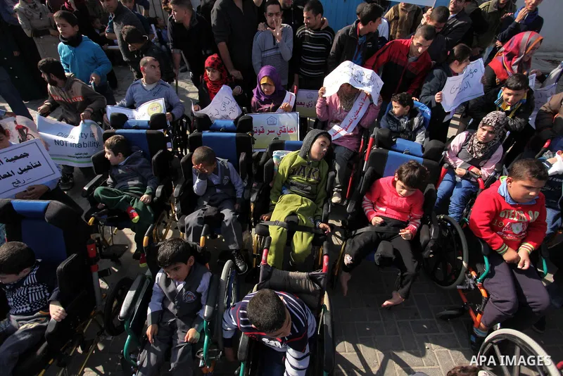 Palestinian girls with disabilities hold banners as they take parts in a rally in Gaza City demanding for the rights of people with disabilities in Gaza on December 5, 2016 Tens of thousands of Gazans are learning to liv...