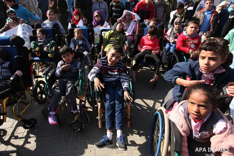 Palestinian girls with disabilities hold banners as they take parts in a rally in Gaza City demanding for the rights of people with disabilities in Gaza on December 5, 2016 Tens of thousands of Gazans are learning to liv...