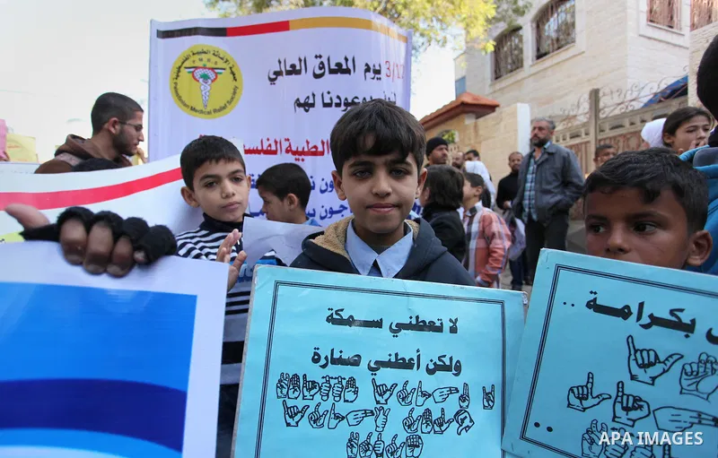 Palestinian girls with disabilities hold banners as they take parts in a rally in Gaza City demanding for the rights of people with disabilities in Gaza on December 5, 2016 Tens of thousands of Gazans are learning to liv...