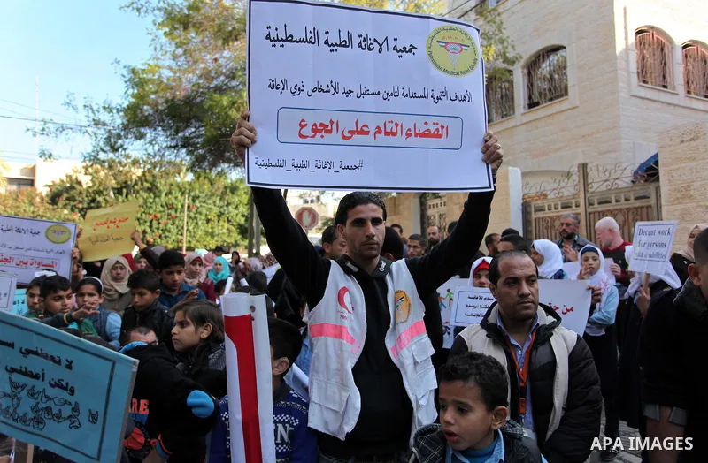 Palestinian girls with disabilities hold banners as they take parts in a rally in Gaza City demanding for the rights of people with disabilities in Gaza on December 5, 2016 Tens of thousands of Gazans are learning to liv...
