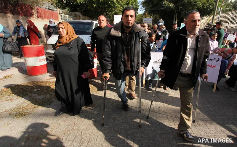 Palestinian girls with disabilities hold banners as they take parts in a rally in Gaza City demanding for the rights of people with disabilities in Gaza on December 5, 2016 Tens of thousands of Gazans are learning to liv...