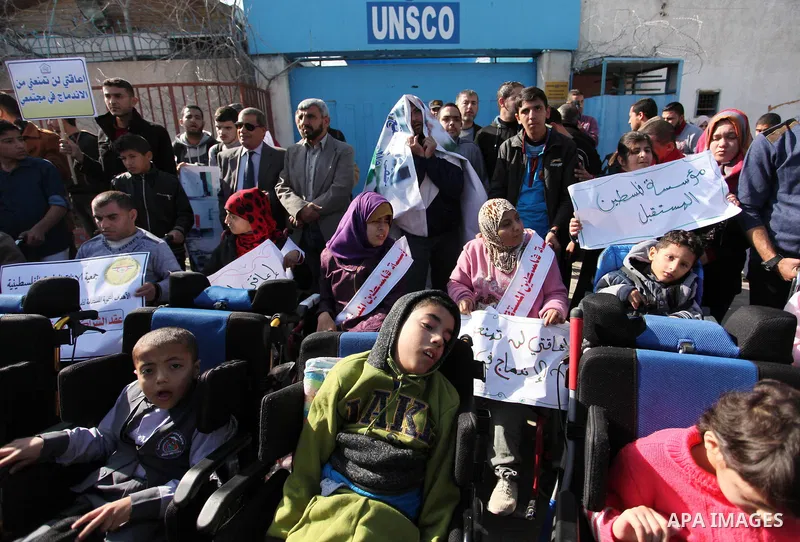 Palestinian girls with disabilities hold banners as they take parts in a rally in Gaza City demanding for the rights of people with disabilities in Gaza on December 5, 2016 Tens of thousands of Gazans are learning to liv...