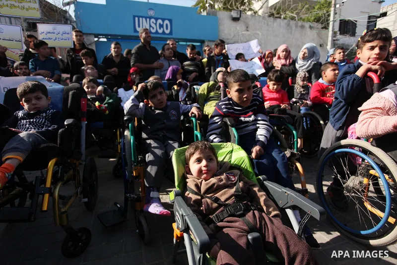 Palestinian girls with disabilities hold banners as they take parts in a rally in Gaza City demanding for the rights of people with disabilities in Gaza on December 5, 2016 Tens of thousands of Gazans are learning to liv...