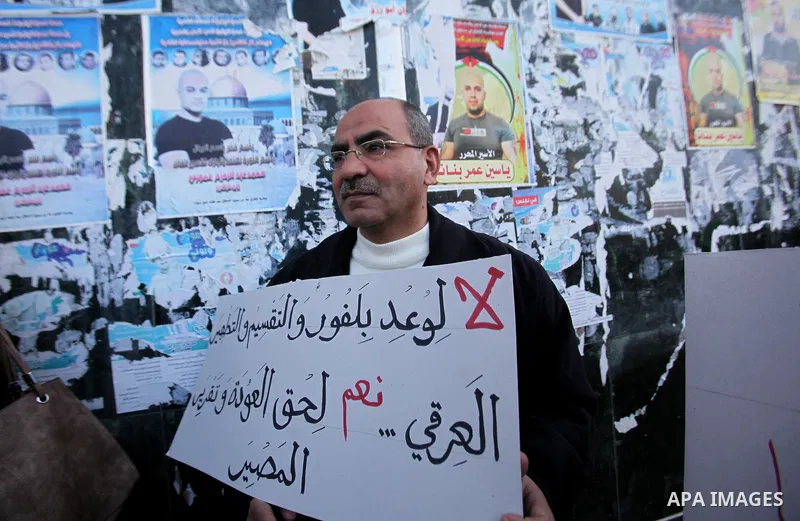 Palestinians hold banners during a campaign of 100 years on the Balfour Declaration, in the West Bank city of Nablus on December 6, 2016. The 1917 Balfour Declaration is a formal statement of policy by the British govern...