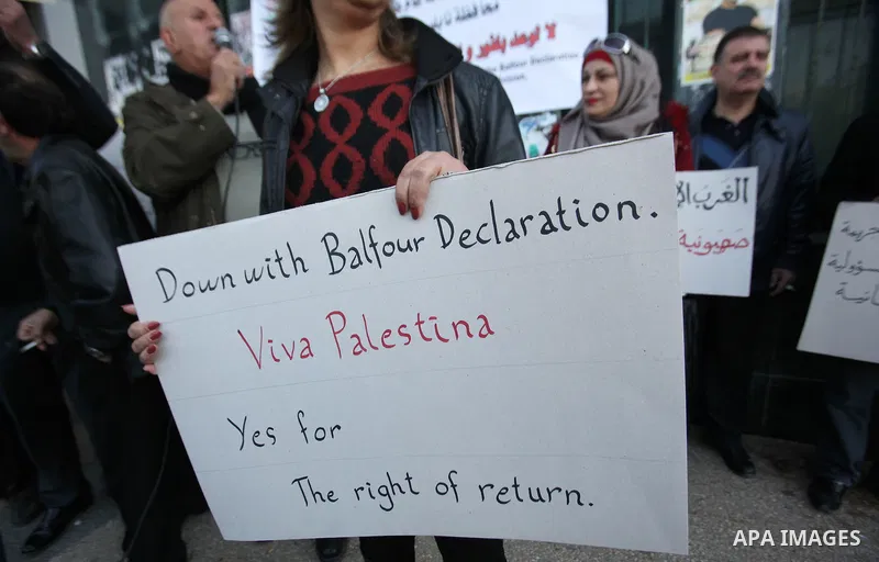 Palestinians hold banners during a campaign of 100 years on the Balfour Declaration, in the West Bank city of Nablus on December 6, 2016. The 1917 Balfour Declaration is a formal statement of policy by the British govern...