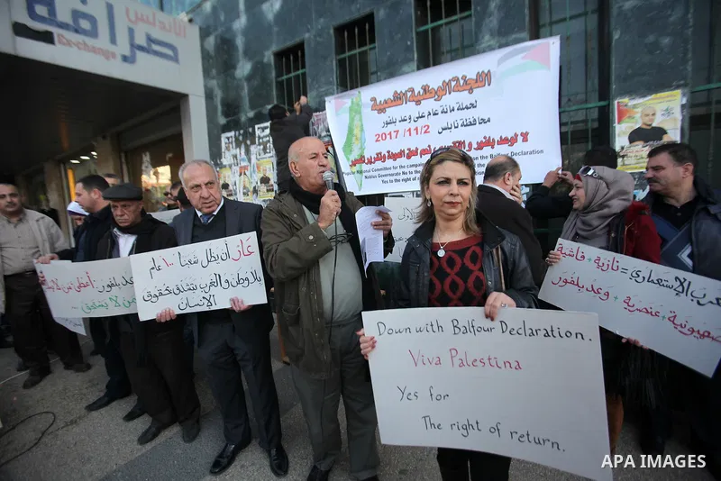 Palestinians hold banners during a campaign of 100 years on the Balfour Declaration, in the West Bank city of Nablus on December 6, 2016. The 1917 Balfour Declaration is a formal statement of policy by the British govern...