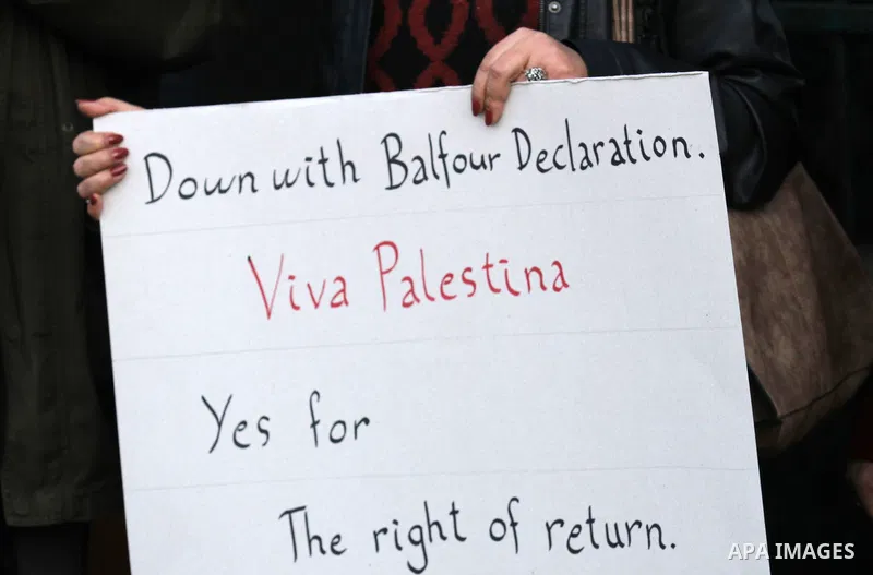 Palestinians hold banners during a campaign of 100 years on the Balfour Declaration, in the West Bank city of Nablus on December 6, 2016. The 1917 Balfour Declaration is a formal statement of policy by the British govern...