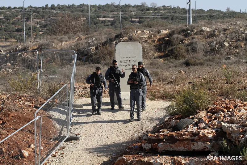 Israeli forces stand near the scene where Israeli paramilitary police officers shot and killed a Palestinian who Israeli police said ran toward them brandishing a knife, near the Israeli Tapouh junction south of the West...