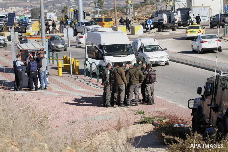 Israeli forces stand near the scene where Israeli paramilitary police officers shot and killed a Palestinian who Israeli police said ran toward them brandishing a knife, near the Israeli Tapouh junction south of the West...