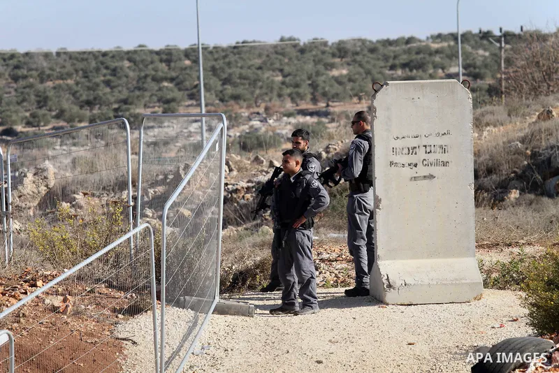 Israeli forces stand near the scene where Israeli paramilitary police officers shot and killed a Palestinian who Israeli police said ran toward them brandishing a knife, near the Israeli Tapouh junction south of the West...