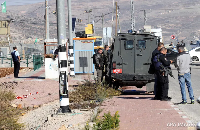Israeli forces stand near the scene where Israeli paramilitary police officers shot and killed a Palestinian who Israeli police said ran toward them brandishing a knife, near the Israeli Tapouh junction south of the West...