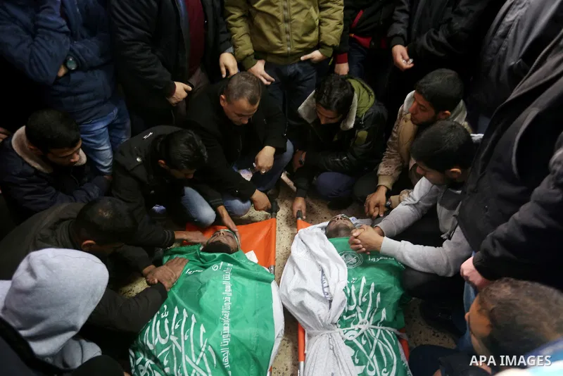 Palestinian Hamas militants with mourners carry the body of their comrade who was killed when a tunnel collapsed on Wednesday, during his funeral in Gaza City December 8, 2016. Photo by Yasser Qudih