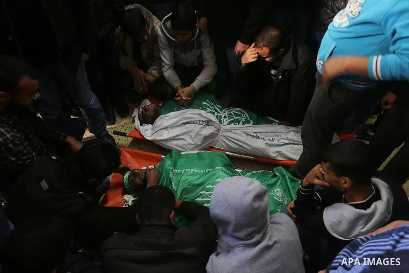 Palestinian Hamas militants with mourners carry the body of their comrade who was killed when a tunnel collapsed on Wednesday, during his funeral in Gaza City December 8, 2016. Photo by Yasser Qudih