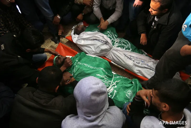 Palestinian Hamas militants with mourners carry the body of their comrade who was killed when a tunnel collapsed on Wednesday, during his funeral in Gaza City December 8, 2016. Photo by Yasser Qudih