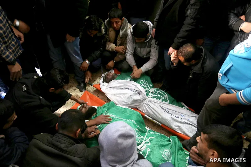 Palestinian Hamas militants with mourners carry the body of their comrade who was killed when a tunnel collapsed on Wednesday, during his funeral in Gaza City December 8, 2016. Photo by Yasser Qudih
