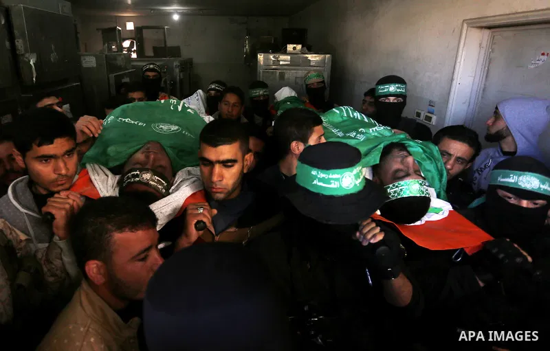 Palestinian Hamas militants with mourners carry the body of their comrade who was killed when a tunnel collapsed on Wednesday, during his funeral in Gaza City December 8, 2016. Photo by Yasser Qudih
