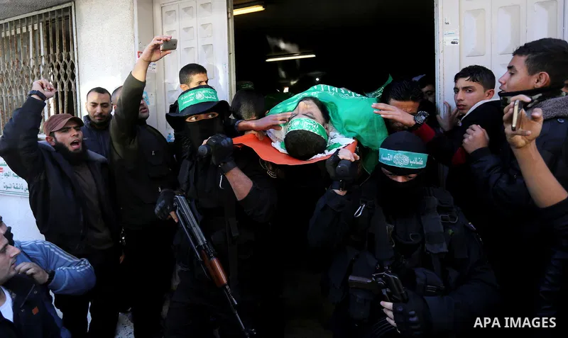 Palestinian Hamas militants with mourners carry the body of their comrade who was killed when a tunnel collapsed on Wednesday, during his funeral in Gaza City December 8, 2016. Photo by Yasser Qudih