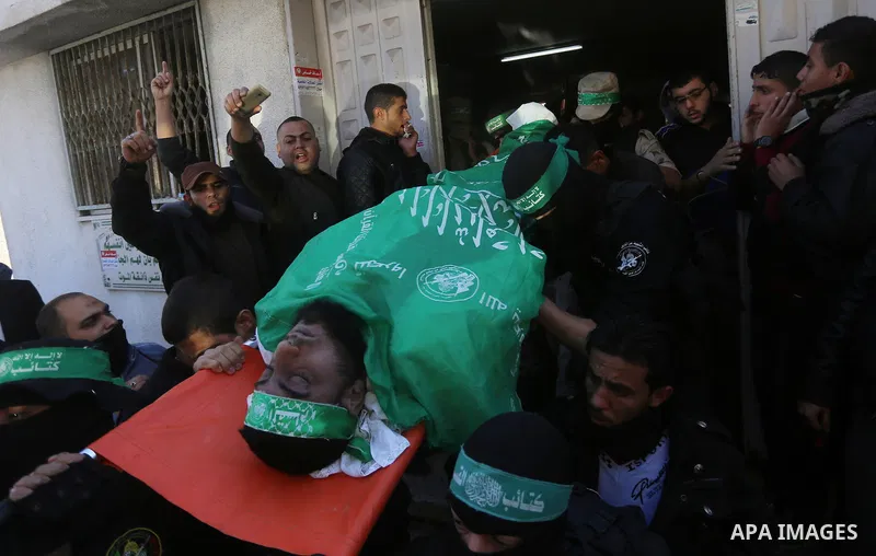 Palestinian Hamas militants with mourners carry the body of their comrade who was killed when a tunnel collapsed on Wednesday, during his funeral in Gaza City December 8, 2016. Photo by Yasser Qudih
