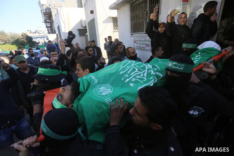 Palestinian Hamas militants with mourners carry the body of their comrade who was killed when a tunnel collapsed on Wednesday, during his funeral in Gaza City December 8, 2016. Photo by Yasser Qudih