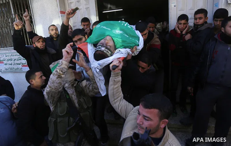 Palestinian Hamas militants with mourners carry the body of their comrade who was killed when a tunnel collapsed on Wednesday, during his funeral in Gaza City December 8, 2016. Photo by Yasser Qudih