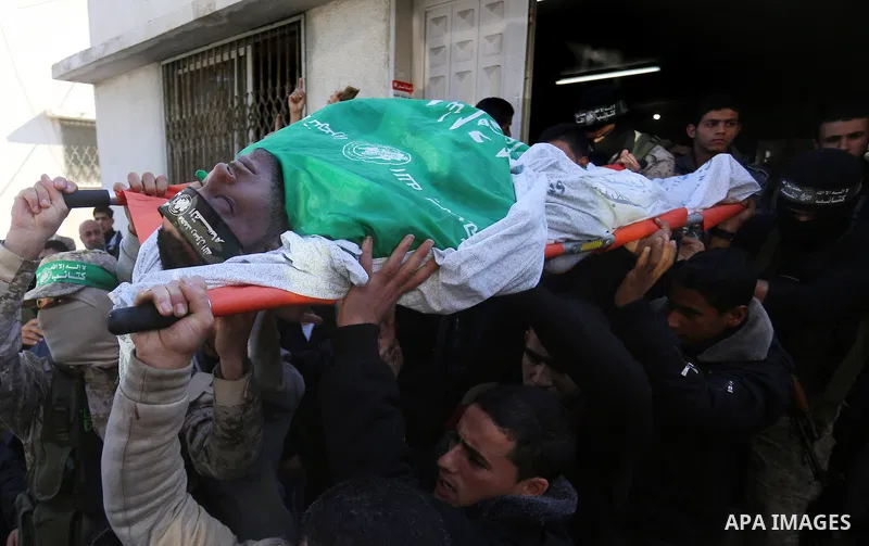 Palestinian Hamas militants with mourners carry the body of their comrade who was killed when a tunnel collapsed on Wednesday, during his funeral in Gaza City December 8, 2016. Photo by Yasser Qudih