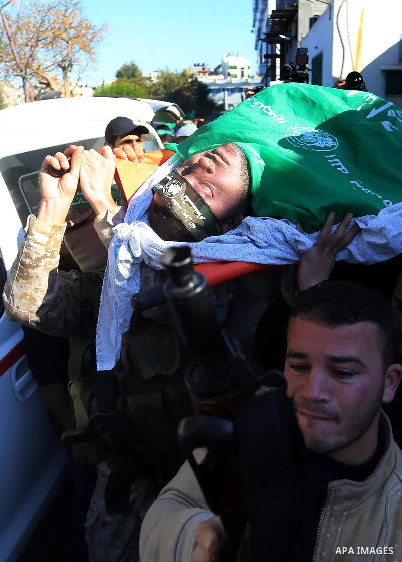 Palestinian Hamas militants with mourners carry the body of their comrade who was killed when a tunnel collapsed on Wednesday, during his funeral in Gaza City December 8, 2016. Photo by Yasser Qudih
