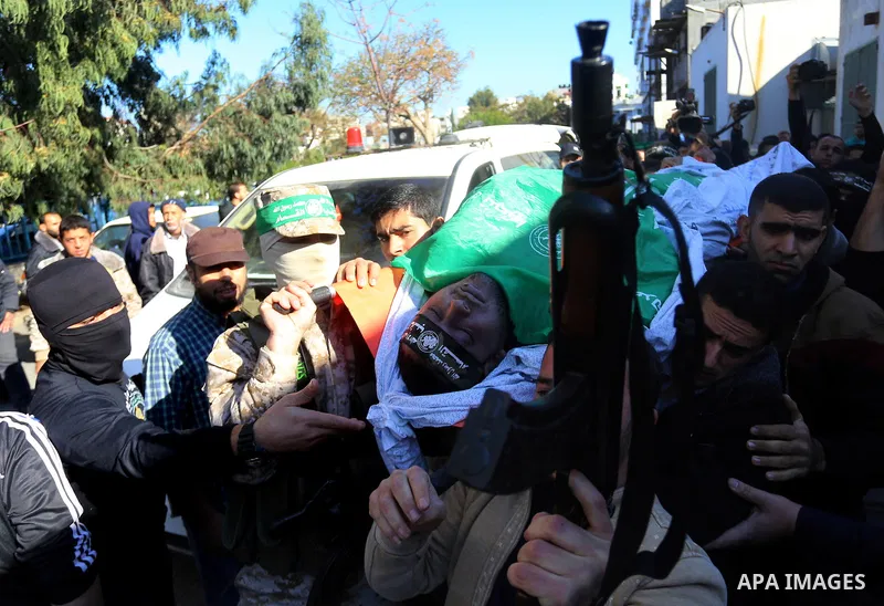Palestinian Hamas militants with mourners carry the body of their comrade who was killed when a tunnel collapsed on Wednesday, during his funeral in Gaza City December 8, 2016. Photo by Yasser Qudih