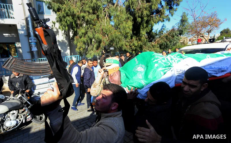 Palestinian Hamas militants with mourners carry the body of their comrade who was killed when a tunnel collapsed on Wednesday, during his funeral in Gaza City December 8, 2016. Photo by Yasser Qudih