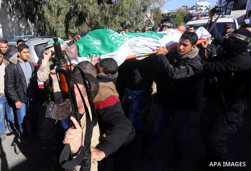 Palestinian Hamas militants with mourners carry the body of their comrade who was killed when a tunnel collapsed on Wednesday, during his funeral in Gaza City December 8, 2016. Photo by Yasser Qudih