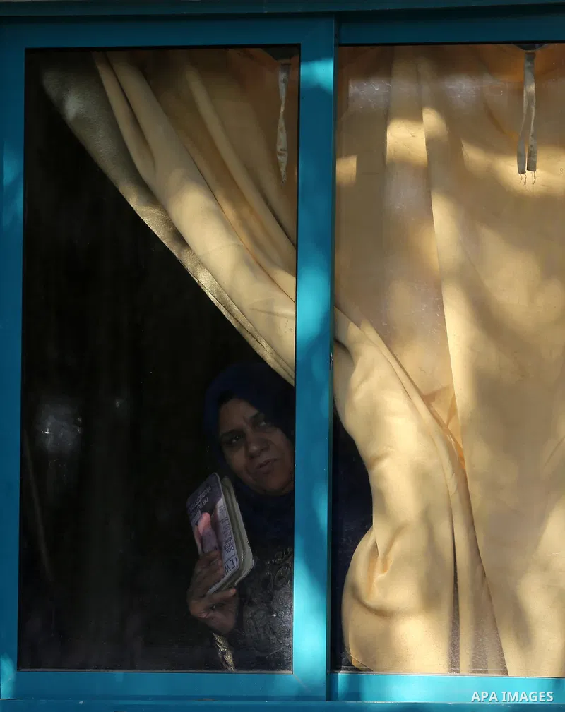 Palestinian women look through a window at the funeral two Hamas militants who were killed when a tunnel collapsed on Wednesday, in Gaza City December 8, 2016. Photo by Yasser Qudih