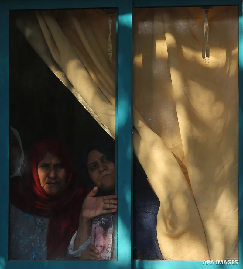 Palestinian women look through a window at the funeral two Hamas militants who were killed when a tunnel collapsed on Wednesday, in Gaza City December 8, 2016. Photo by Yasser Qudih